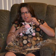Jen holding up cow bank at baby shower