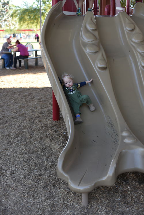 Remy going down slide with a scared look