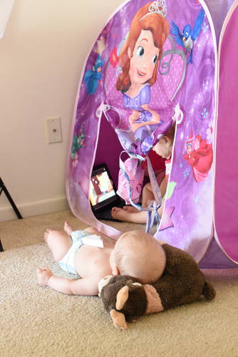 Priay watching iPad in her princess tent
