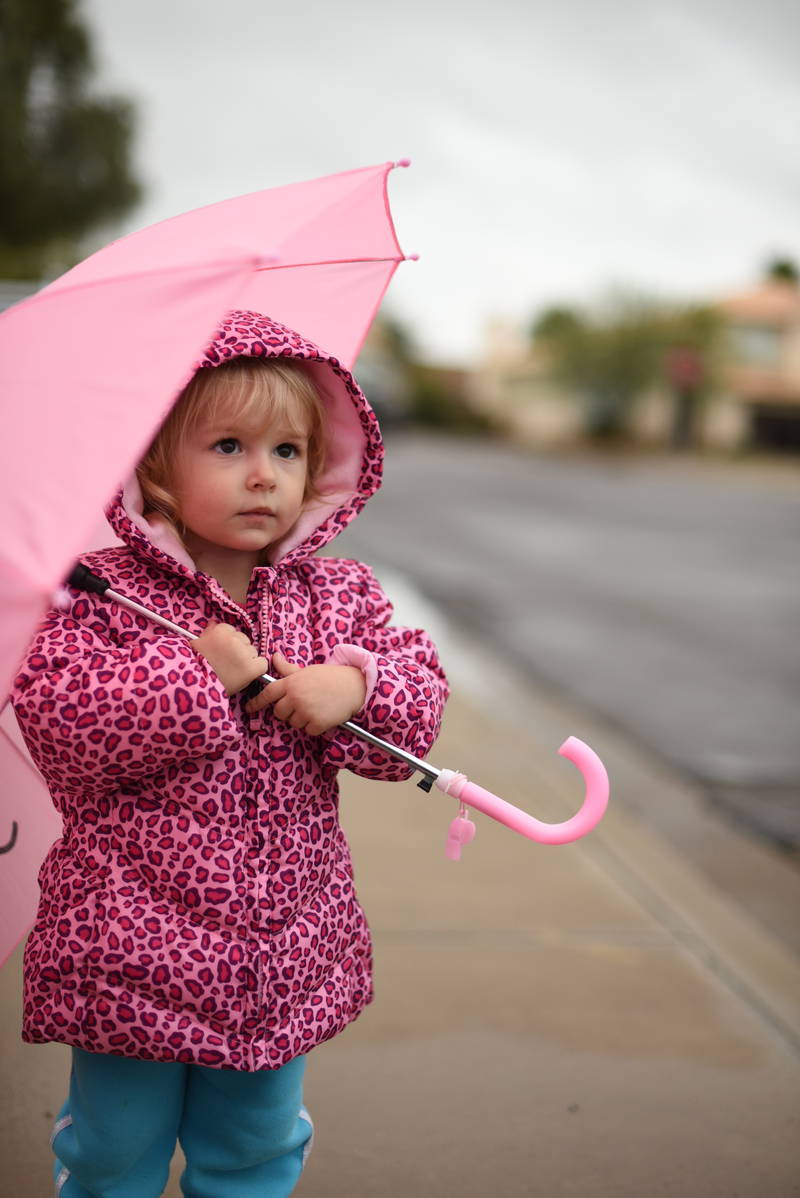 Priya holding her umbrella in the rain